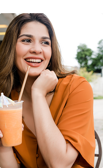 woman-drinking-fresh-fruit-juice-outdoors-XUMWH86.png